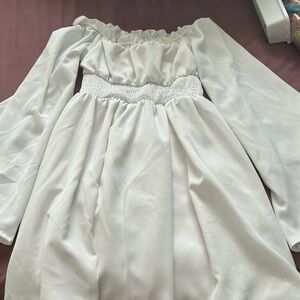 a white off the shoulder dress